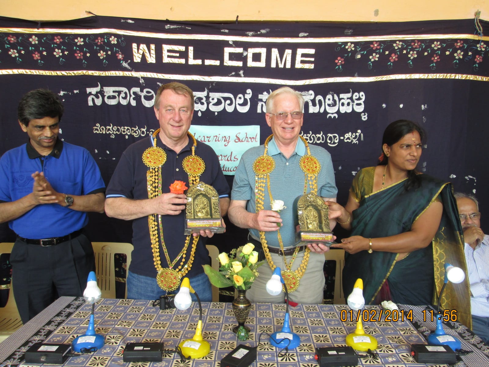 Rtns Don and Bob being felicitated by the HM as Rtn. Rajendra Rai applauds