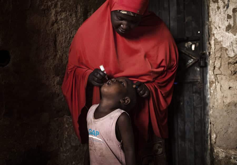 A child receives a polio vaccine during National Immunization Days in the Nigerian city of Kano.